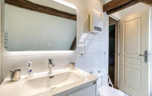 a white bathroom with a sink and a toilet at Les Bouyssières in Creysse