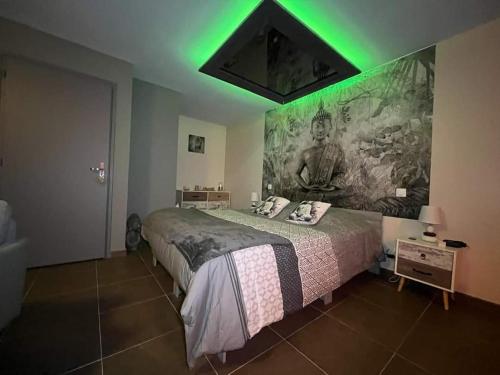 a bedroom with a large bed with a green ceiling at Le pont des rêves in Pont-sur-Sambre