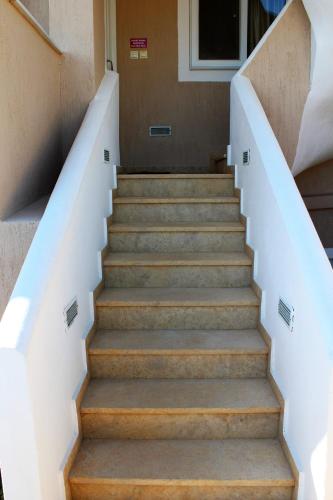 a set of stairs in a building with a stair case at Helen's Sounio Apartments in Sounio