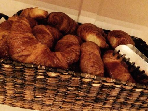 a basket full of croissants and breads at Lodges Veluwse Poort in Dieren
