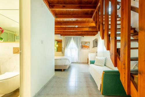 a living room with a bed and a bathroom at Jacob Ha-Tzayadim in Geʼullim