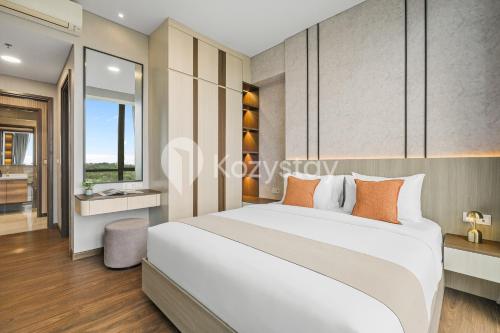 a bedroom with a large white bed and a bathroom at Velir by Kozystay - BSD in Cilenggang