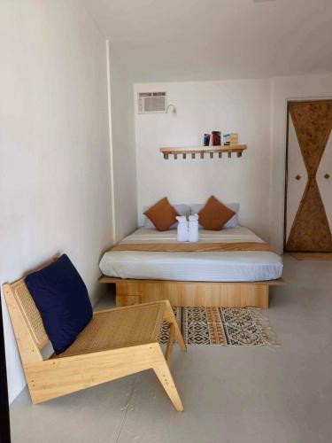 a bedroom with a bed and a bench in it at Ocam Ocam Bayside Lodge in Busuanga