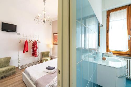 a bathroom with a sink and a bed in a room at Casamia Tuscan Oasis 4Br Panoramic Penthouse Hot Tub & Easy Parking in Siena