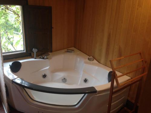 a large bath tub in a room with a window at Casa de las Hazas in Poyatos