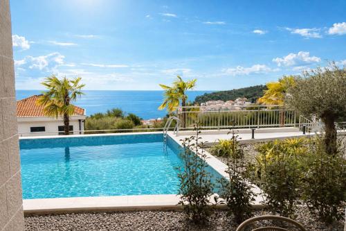 a swimming pool with a view of the ocean at Olive apartments in Petrovac na Moru