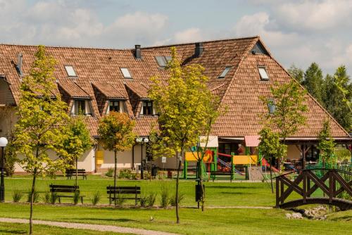 a large building with trees in front of it at Hotel - Restauracja Platan in Sędziszów Małopolski