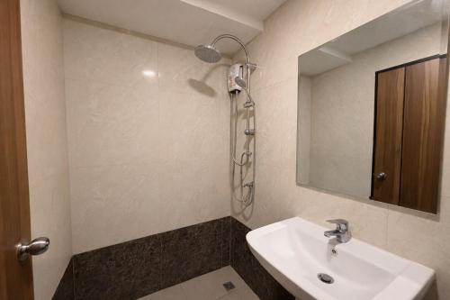 a bathroom with a sink and a shower at MaiKhao Sunrise Sight Space in Ban Mai Salae