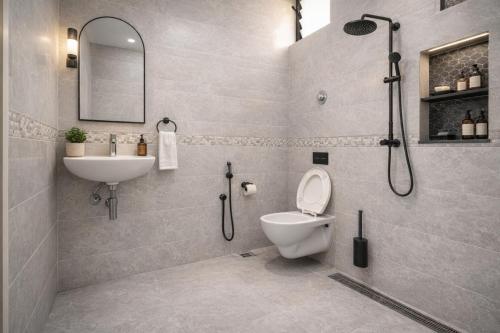 a bathroom with a toilet and a sink and a shower at Hotel PKD Vrindavan Near 100 Futta Main Road in Vrindāvan