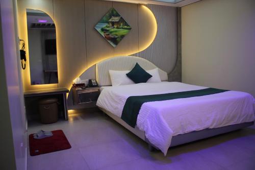 a bedroom with a large bed and a mirror at City Inn Ltd in Khulna