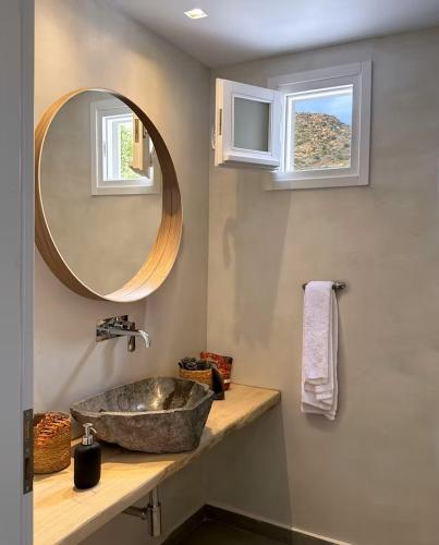 a bathroom with a sink and a mirror at Olive Tree Homes in Ios Chora
