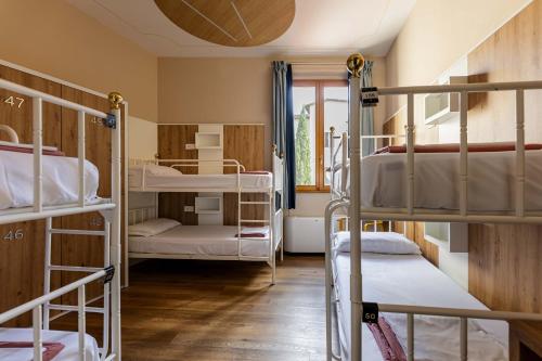 a dorm room with bunk beds and a window at Hostel Archi Rossi in Florence