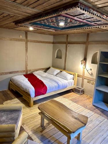 a bedroom with a bed and a wooden floor at Zimsa Resort Skardu in Skardu