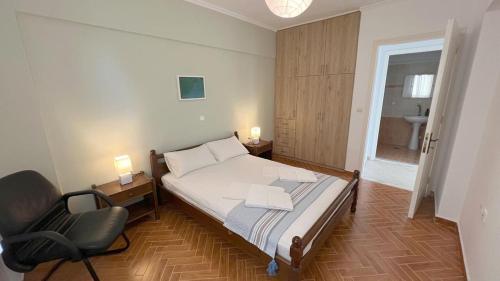 a bedroom with a bed and a chair in it at Villa Evgenia in Yénion