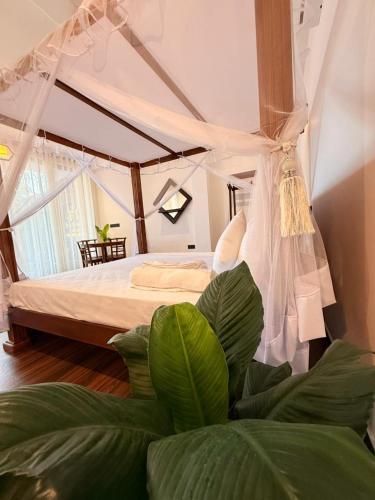 a bedroom with a bed with a canopy at La Brisa By Harry Beach Villa in Dickwella