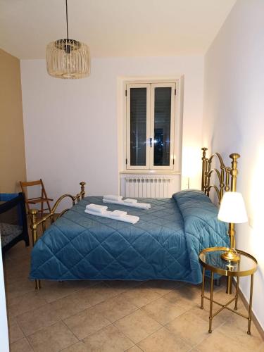 a bedroom with a blue bed and a window at Ai piedi del Morrone in Tocco da Casauria
