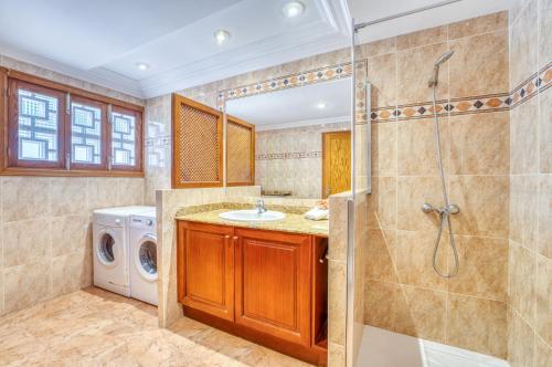 a bathroom with a shower and a sink and a washing machine at Ideal Property Mallorca - Christin in Cala Ratjada