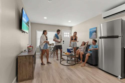 a group of people standing in a living room at Steps to Beach Fully Renovated Sleeps 6 in Hampton