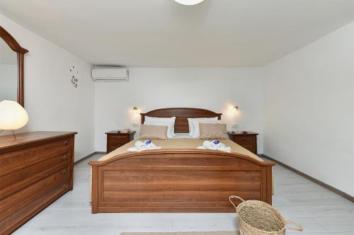 a bedroom with a wooden bed with two towels on it at House Kanižela 2418 in Nova Vas