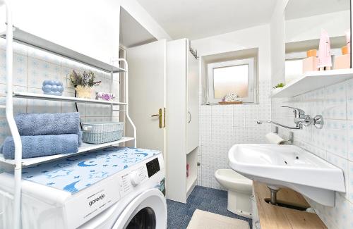 a washing machine in a bathroom with a sink at House Kanižela 2418 in Nova Vas