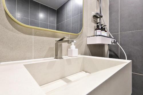 a white sink in a bathroom with a mirror at Hotel Coolstay Gimcheon in Gimcheon