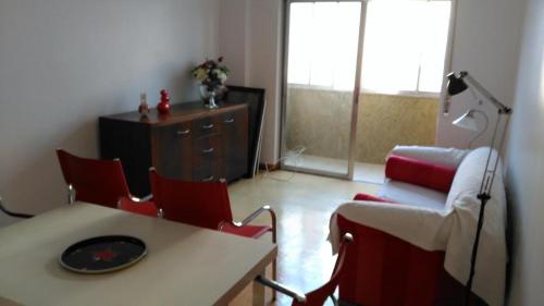 a living room with a table and chairs and a couch at Apartamento Avenida 5 de Outubro in Lisbon