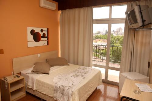 Ένα ή περισσότερα κρεβάτια σε δωμάτιο στο Estrela Palace Hotel