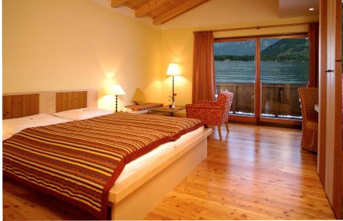 a bedroom with a bed and a view of the water at Seevilla Freiberg in Zell am See