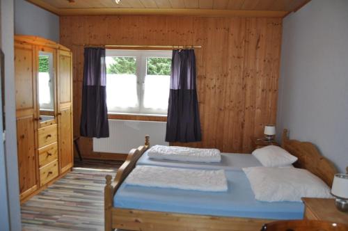 a bedroom with a bed and a window at Suederhof-Diemelsee in Diemelsee