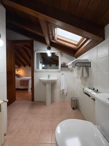 a bathroom with a sink and a toilet at Eco de las Cuevas in Santillana del Mar