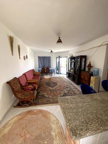 a living room with chairs and a table at Golden Beach 2 Resort in Ras Sedr