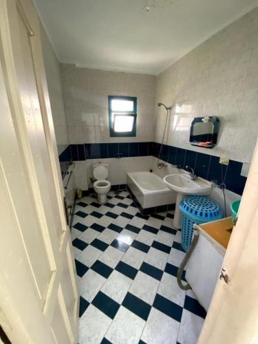 a bathroom with a tub and a toilet and a sink at Golden Beach 2 Resort in Ras Sedr