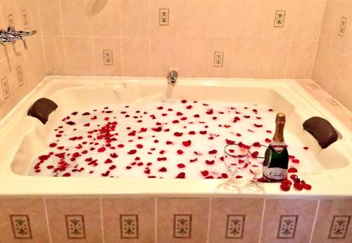 a bath tub filled with red hearts at Hotel Villa Real Antigua in Antigua Guatemala