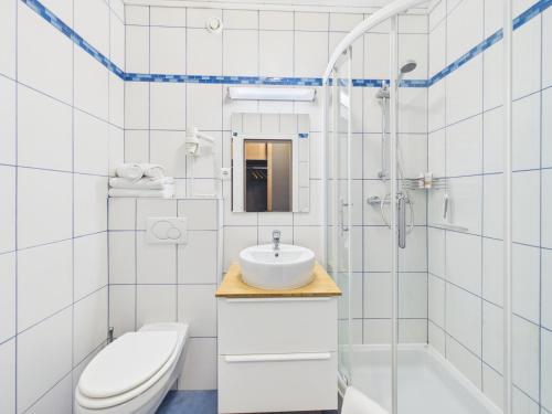 a white bathroom with a sink and a toilet at Boutique73 Sunrise in Ossiach