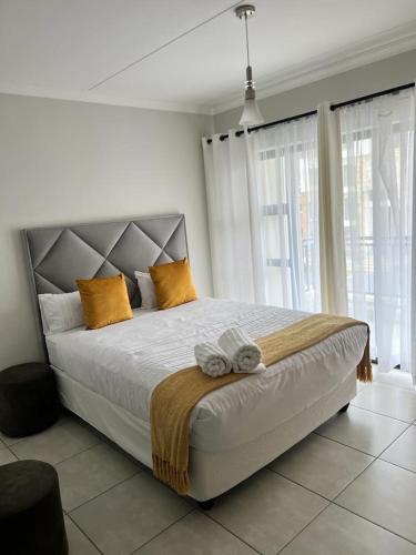 a bedroom with a large bed with yellow pillows at The lagoon retreat in Avondzon