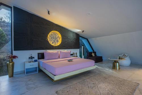 a bedroom with a pink bed and a large window at SaffronStays Luna Celeste in Rānīkhet