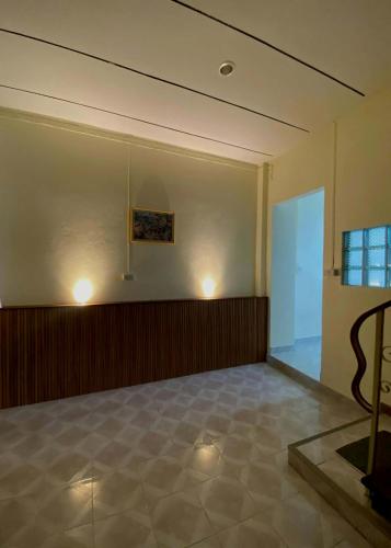 an empty room with a large room with a glass door at HOM's HOSTEL in Phuket