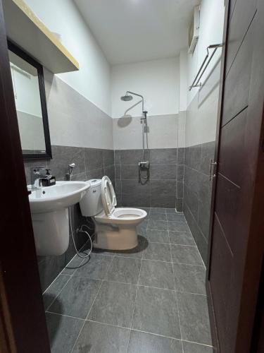 a bathroom with a sink and a toilet and a shower at La Me Villa Hoi An in Hoi An
