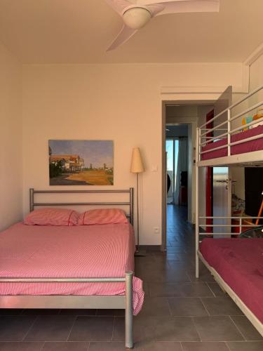 a bedroom with two beds and a bunk bed at Vue Mer - appartement de charme - accès direct plage in Leucate-Plage