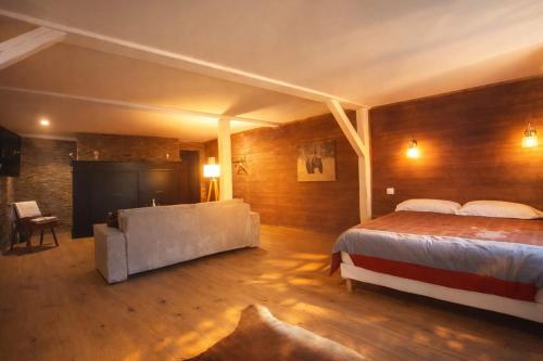 a bedroom with a bed and a tub in it at Le RELAIS in Lézat-sur-Lèze