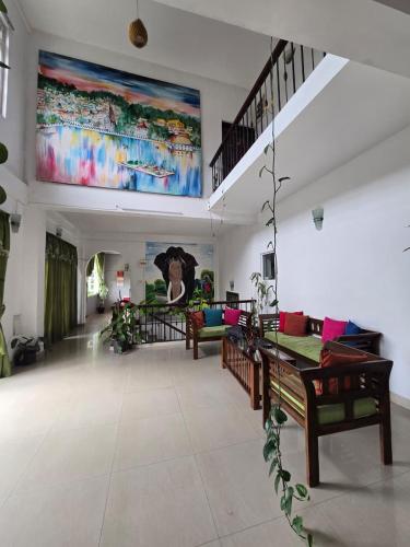 a living room with a large painting on the wall at Hotel Blue Mount View Kandy in Kandy