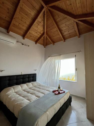 a large bed in a room with a window at Sun Gazing Villas in Drymon