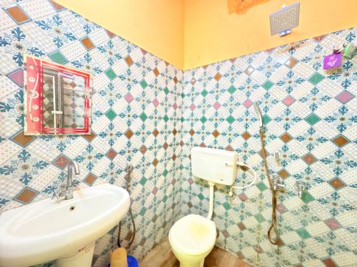 a bathroom with a sink and a toilet at Manas Kanya Mandarmani Hotel & Restaurant - Swimming Pool - Banquet - Parking Facility Full AC Room in Mandarmoni
