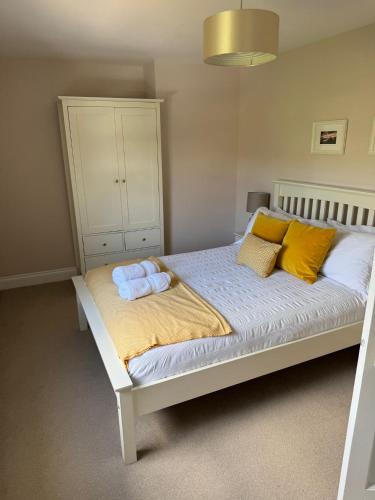 a bedroom with a bed with two towels on it at Two bedroom house in central Portree in Portree