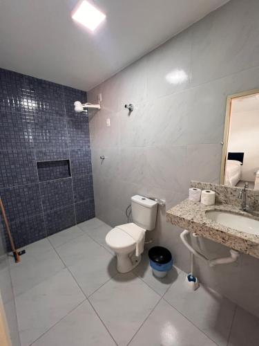 a bathroom with a toilet and a sink and a shower at Pousada Flat Lourdes Residence in Angicos
