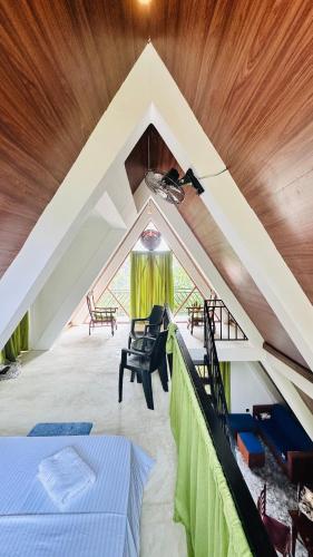 a attic room with a bed and a chair at Thesrilankaman village in Unawatuna