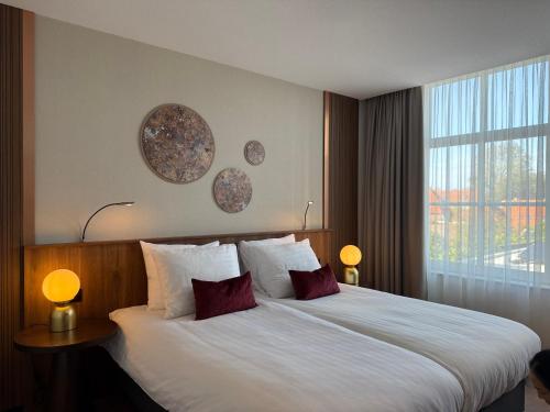 a hotel room with a large bed with two pillows at Zen Kitchen & Boutique Hotel in Brouwershaven