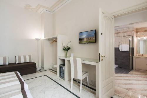 a living room with a table and a couch at Otium in Sorrento in Sorrento