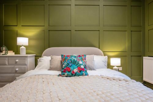a bedroom with a large bed with a pillow on it at The Leiston, 1 Valley Road in Leiston