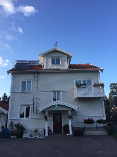 a large white house with a tower on top of it at Lexe 2rok in Gävle